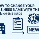 Illustration showing a business building, a clipboard with a checklist, and the IRS logo with a ‘NEW’ sign — representing the process of changing a business name with the IRS. Text reads: ‘How to Change Your Business Name with the IRS: An SMB Guide.