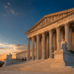 U.S. Supreme Court building at dusk with American flag, representing Virginia redistricting referendum legal battle and 2026 midterm elections